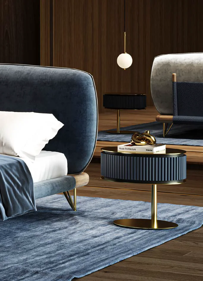 Naurelle bedroom with a blue velvet bed and a round fluted bedside table