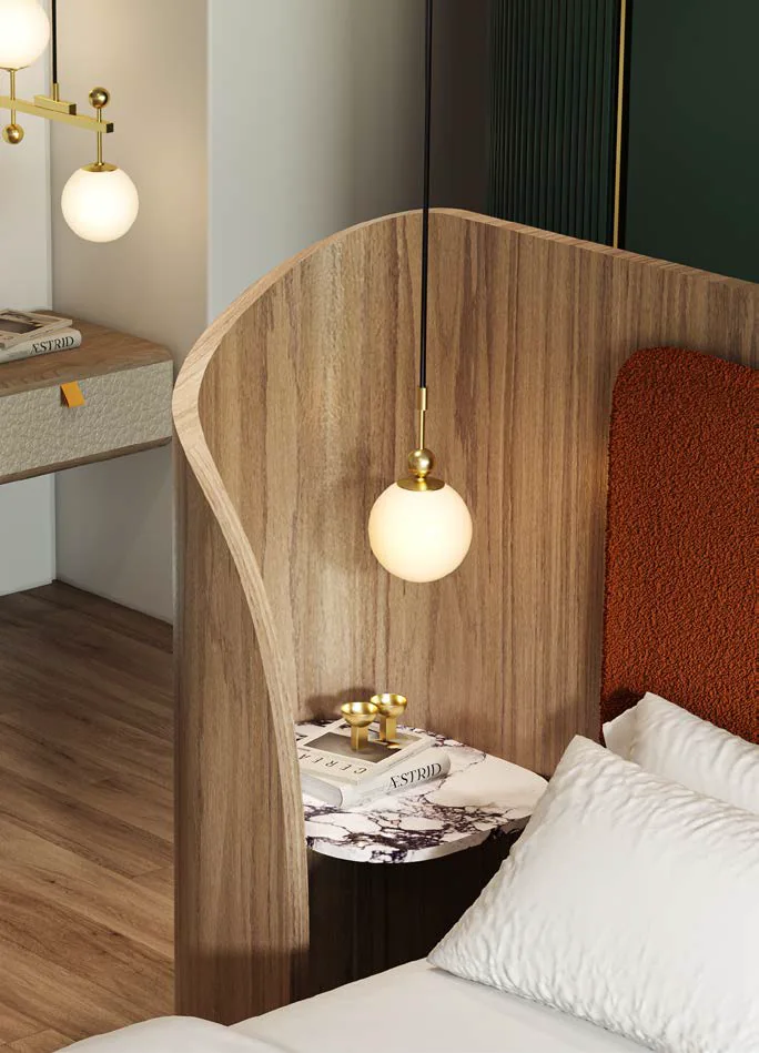 Naurelle bed with a curved wooden headboard and a glass pendant light