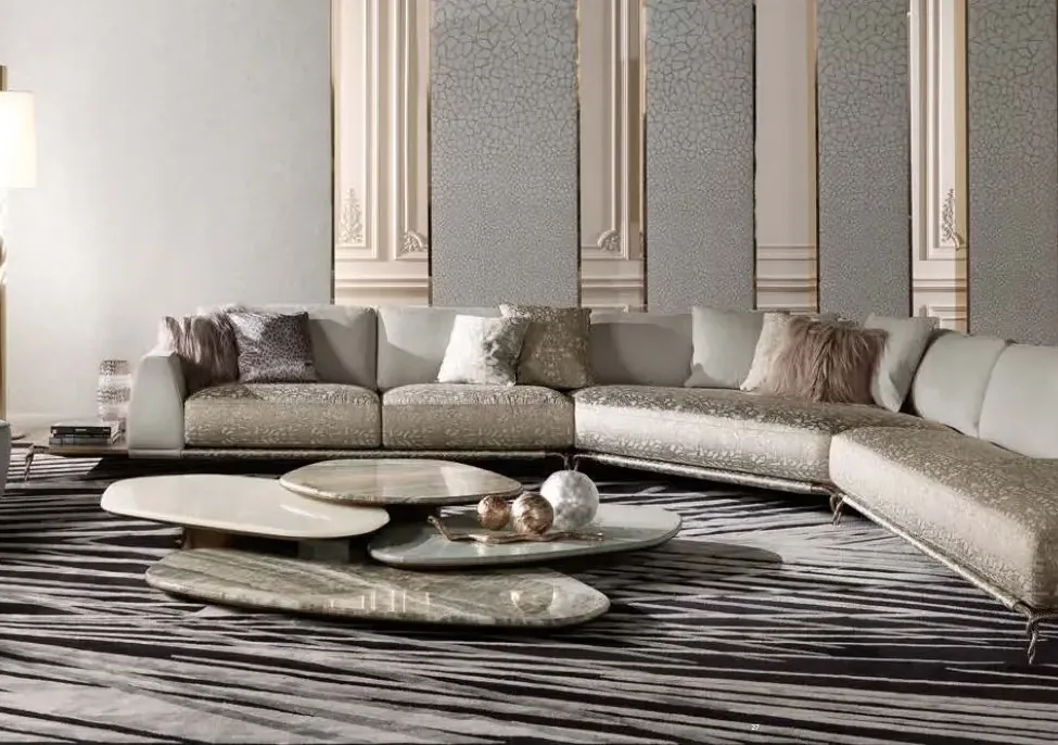 Living room with a curved sectional sofa and stone coffee tables