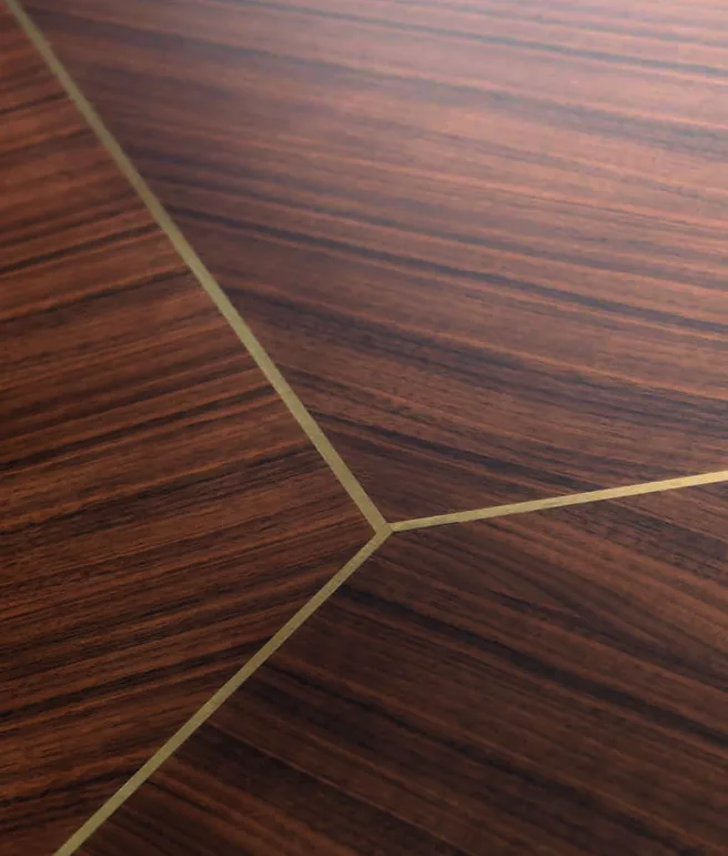 Close-up of walnut veneer with brass inlay