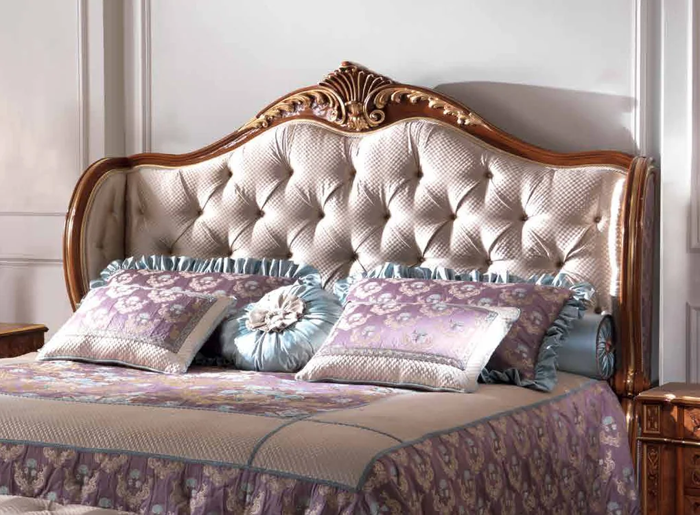 Luxury II catalogue: classic bed with a carved walnut frame and tufted headboard