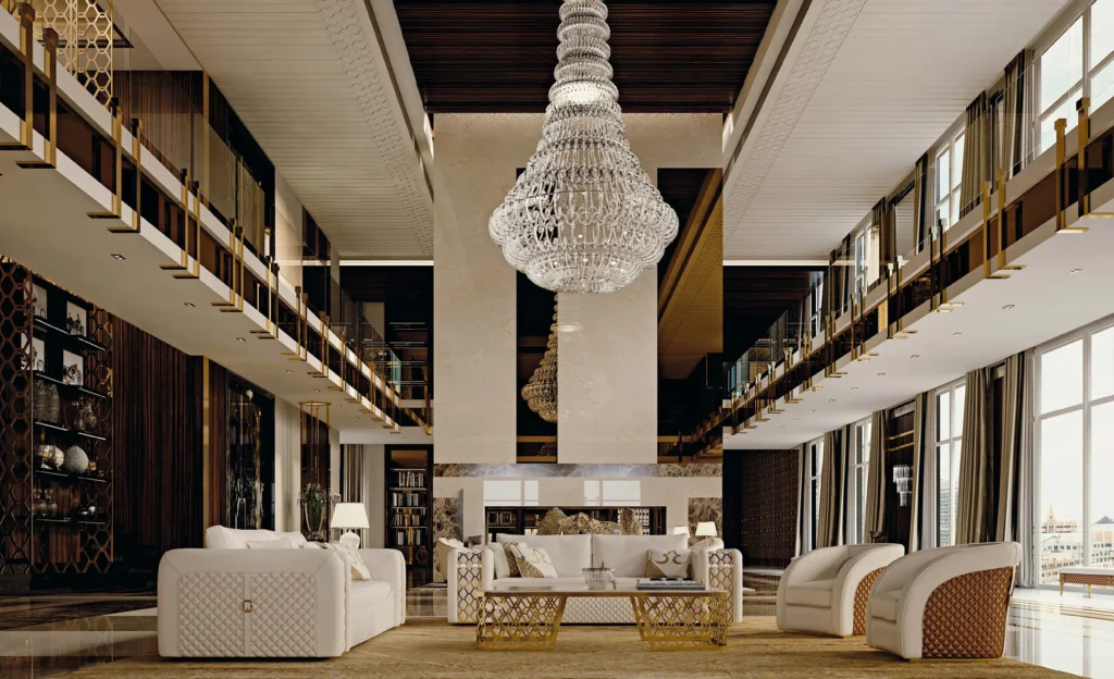 Double-height living room with a crystal chandelier, cream sofas and a gallery above