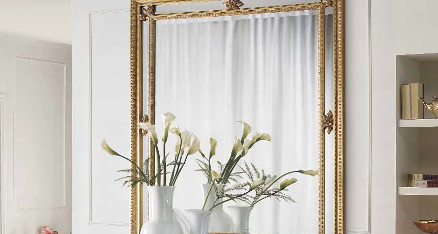 Entry Consoles and Mirrors catalogue: gilded mirror above a console with white calla lilies