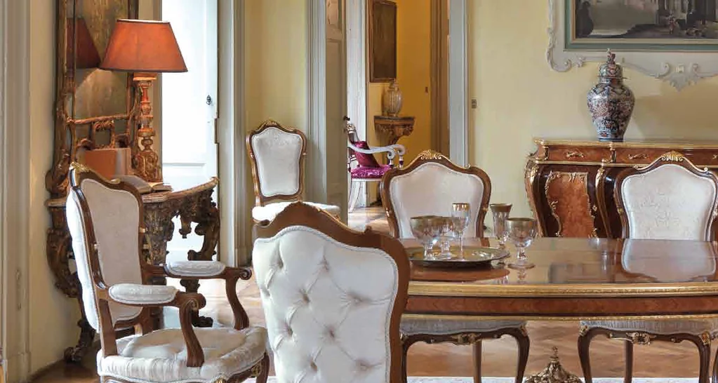 GL Collection catalogue: classic dining room with white tufted chairs and an inlaid table